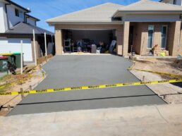 New concrete driveway constructed by AGC Landscapes in the Gold Coast